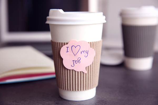 I love my job concept. Cup with hot coffee on grey table